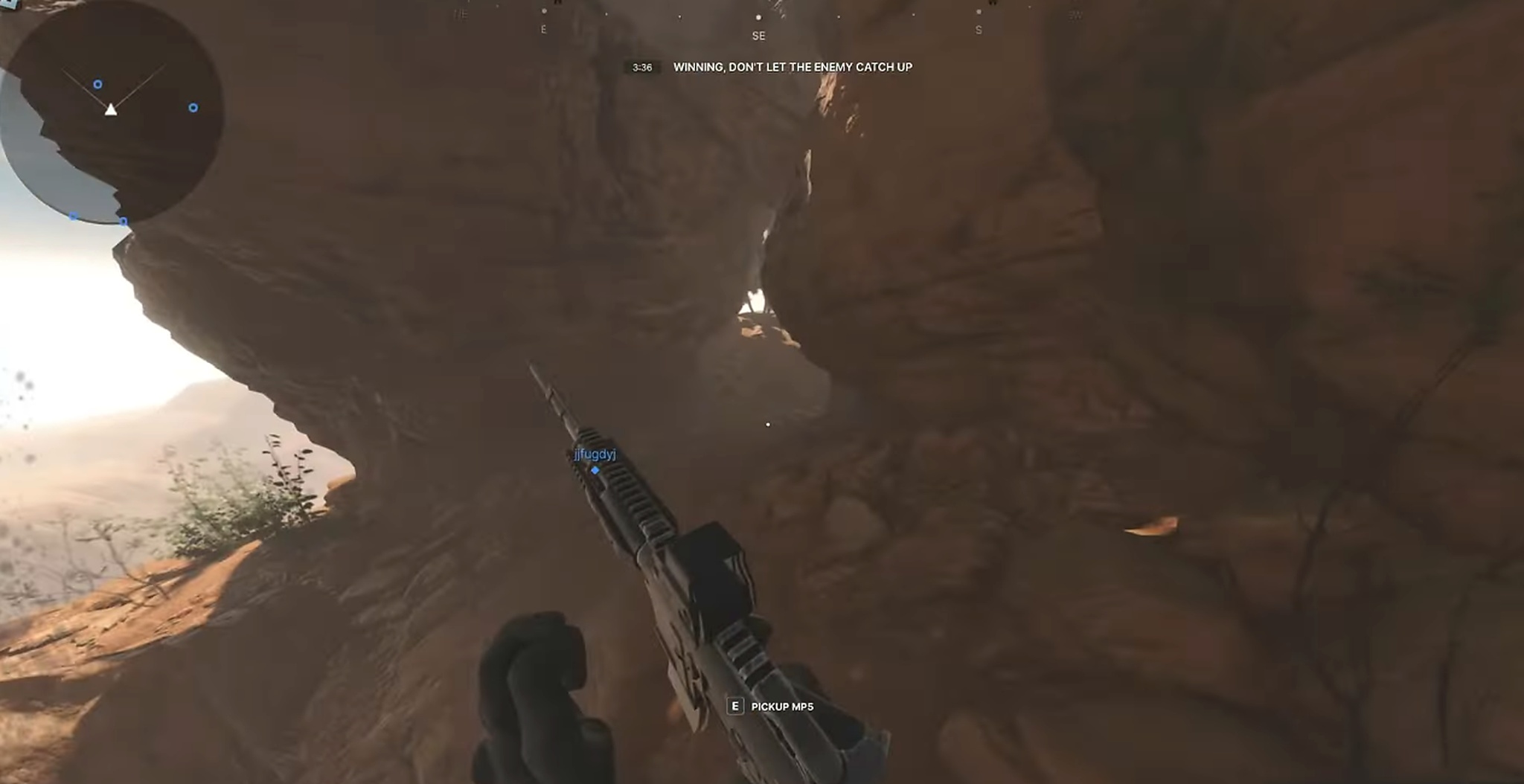 Frontlines first-person shooter in a desert canyon; the player aims a sniper rifle with an MP5 pickup prompt.